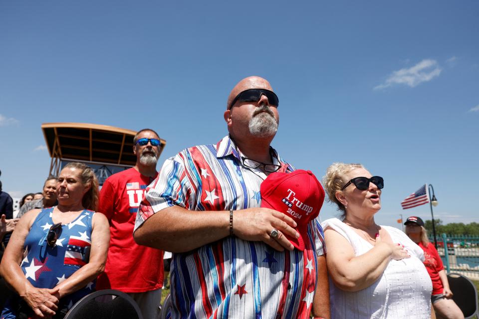 People sing national anthem as they attend a campaign event held by former U.S. President and Republican presidential candidate Donald Trump, in Racine, Wisconsin (REUTERS)