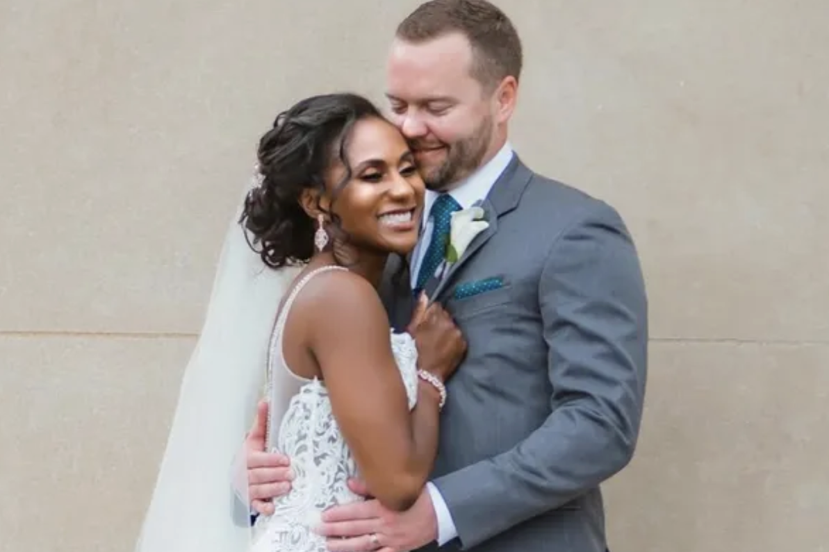 Former Kansas City Chiefs cheerleader Krystal Anderson, in a wedding dress, and her husband, Clayton. 