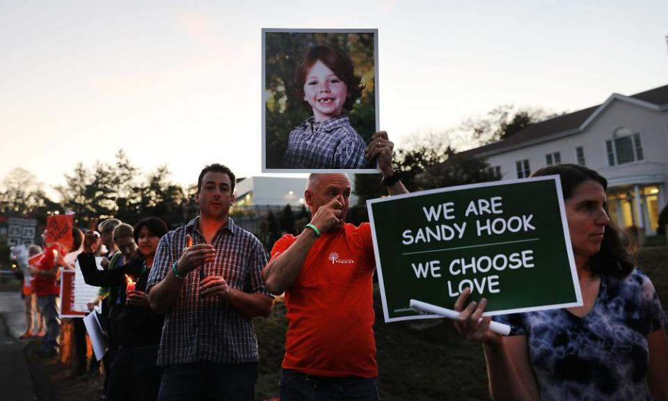 Mark Barden holds up a picture of his son Daniel, who was killed at Sandy Hook, during a vigil remembering the 59 people killed in Las Vegas this week.