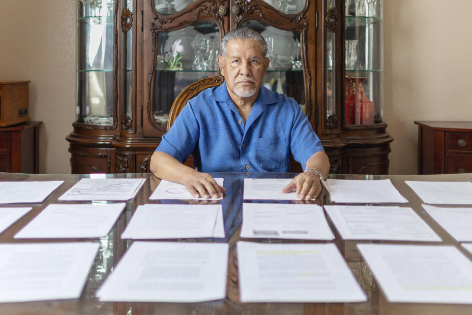 In this undated photo provided by the Institute for Justice, Vietnam veteran José Oliva reviews documents from his lawsuit after he was put in a chokehold and thrown to the ground by federal police officers in an altercation that was caught on camera at the VA hospital in El Paso, Texas in 2016. (Institute for Justice via AP)