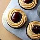 <p>With a peanut butter chocolate ganache filling, these might be the most <a rel="nofollow noopener" href="https://www.countryliving.com/food-drinks/g761/cupcake-decorating-ideas-0309/" target="_blank" data-ylk="slk:elegant cupcakes;elm:context_link;itc:0;sec:content-canvas" class="link ">elegant cupcakes</a> we've ever seen.</p><p><strong>Get the recipe at <a rel="nofollow noopener" href="http://joanne-eatswellwithothers.com/2012/03/recipe-peanut-butter-and-jelly-cupcakes-with-peanut-butter-chocolate-ganache.html#_a5y_p=3543920" target="_blank" data-ylk="slk:Eats Well With Others;elm:context_link;itc:0;sec:content-canvas" class="link ">Eats Well With Others</a>.</strong></p>