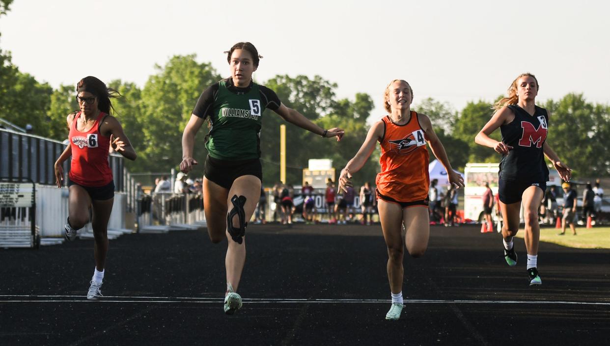 Williamston freshman MacKynzie Bush (5) beats Annabelle Densmore (4) of Charlotte to the tape in the 100 meter dash, Tuesday, May 30, 2023, at the Greater Lansing Honor Roll Meet at Waverly. Also pictured is Sexton's Ka'Myra Wade, left, and Tori Lator of Mason.