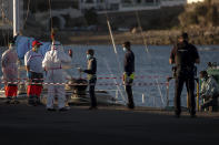 A boy has his temperature taken as he arrives with others migrants at the Arguineguin port in Gran Canaria island, Spain, after being rescued in the Atlantic Ocean by emergency workers on Thursday, Aug. 20, 2020. Migrants and asylum seekers are increasingly crossing a treacherous part of the Atlantic Ocean to reach the Canary Islands, a Spanish archipelago near West Africa, in what has become one of the most dangerous migration routes to European territory. (AP Photo/Emilio Morenatti)