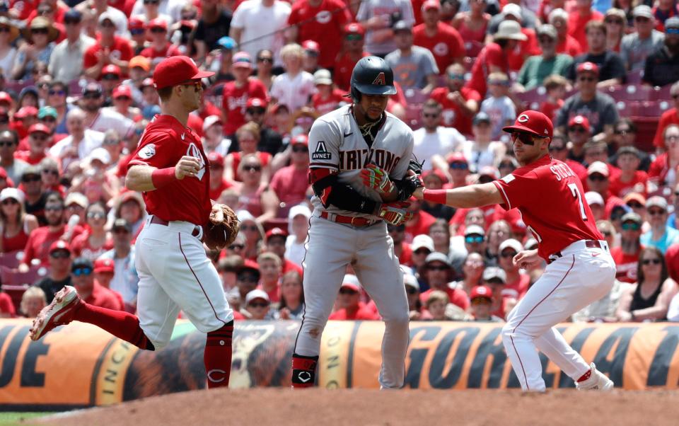 Spencer Steer tags Ketel Marte during the Reds' sweep of the Diamondbacks at home last month.