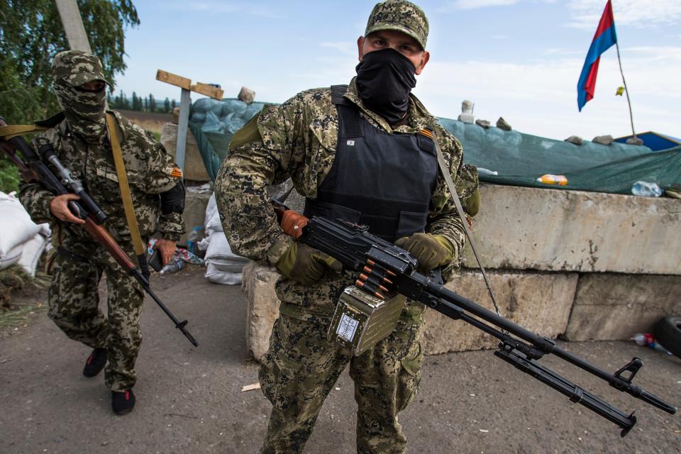 In May 2014, masked pro-Russian armed militants guard a checkpoint with a Russian national flag on the right, blocking the major highway which links Kharkiv, outside Slovyansk, Ukraine. Russia's present demands are based on President Vladimir Putin's purported long sense of grievance and his rejection of Ukraine and Belarus as truly separate, sovereign countries but rather as part of a Russian linguistic and Orthodox motherland.