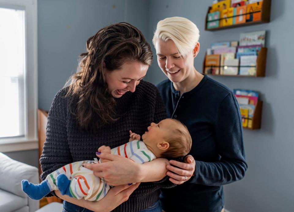 Corinne Rockoff, left, of Ferndale, makes faces and laughs with her son Sawyer Basin after feeding him while standing in his room with her wife, Alicia Basin, at their home in Ferndale on Jan. 27, 2023. Rockoff is worried about their parental rights should something happen to one of them or the marriage. The two would prefer to spend their maternity leaves adoring their new baby. But they're spending precious time and emotional energy filing for adoption to ensure Rockoff, who did not carry and give birth to Sawyer, has the same parental rights as her wife.