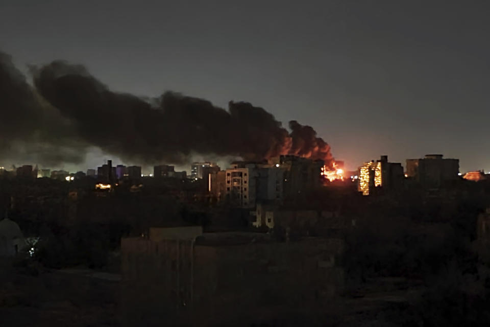 Smoke rises over the horizon as a fire burns after a strike in Khartoum, Sudan, Sunday, April 16, 2023. Washington's top diplomat said Tuesday, April 18, 2023, that a U.S. Embassy convoy came under fire in Sudan and denounced "indiscriminate military operations" as the country's armed forces and a powerful rival unleashed heavy weapons in urban areas for a fourth day. (AP Photo/Abdullah Moneim)