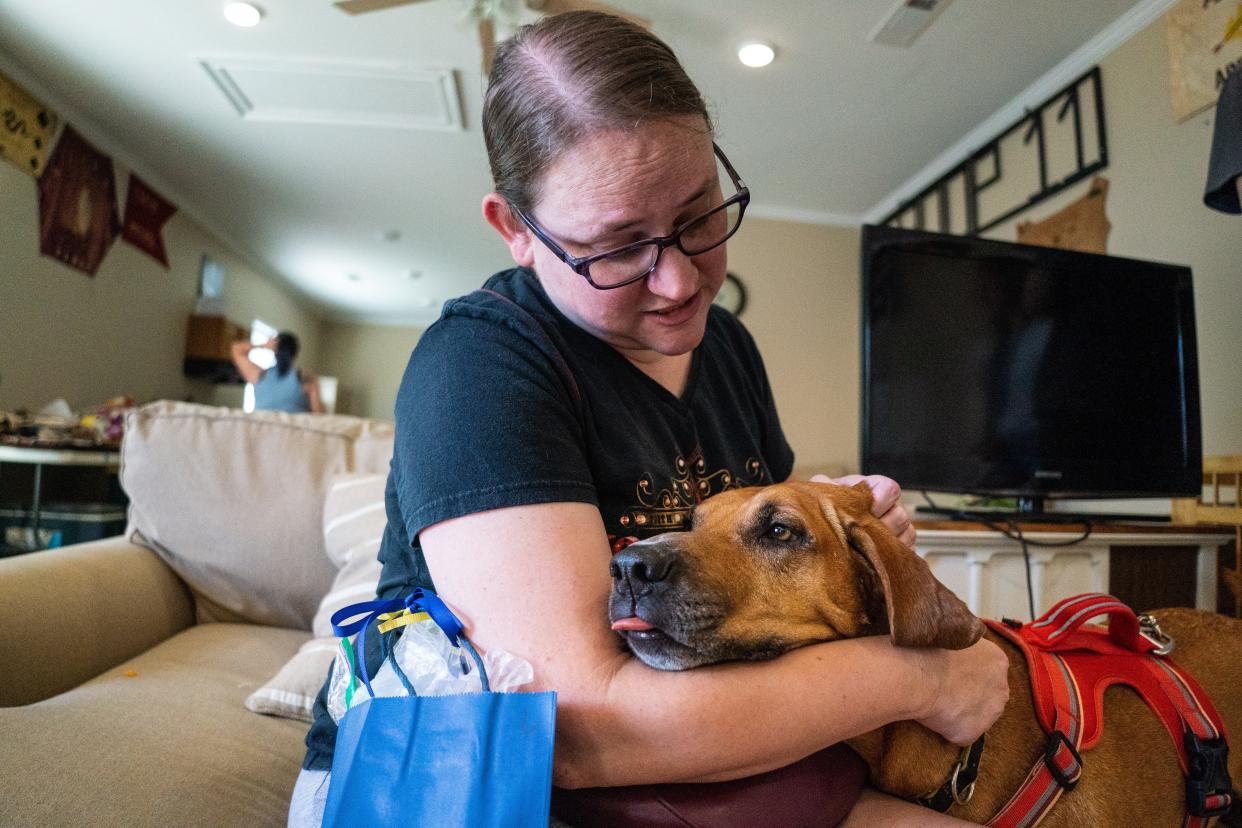 Valerie Trull holds her dog Mercer after adopting him during the Tuscaloosa Metro Animal Shelter’s Big Dogs, Big Hearts adoption event in honor of Alabamian-Ukrainian POWS Andy Huynh and Alex Drueke outside of Forest Lake United Methodist Church. Saturday August 13, 2022. [Photo/Will McLelland] 