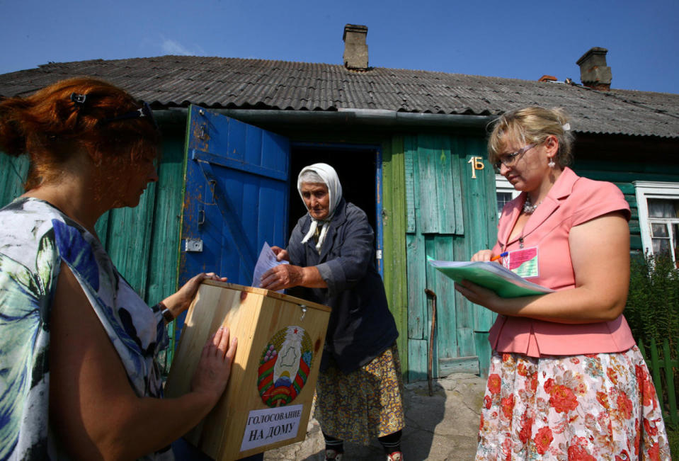 Woman casts her ballot during a parliamentary election in the village of Zhukov Lug