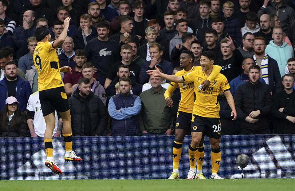 Wolverhampton Wanderers' Hwang Hee-chan foreground right, celebrates with Nelson Semedo and Raul Jimenez, left, after scoring their side's first goal of the game, during the English Premier League soccer match between Leeds United and Wolverhampton Wanderers, at Elland Road, in Leeds, England, Saturday, Oct. 23, 2021. (Zac Goodwin/PA via AP)