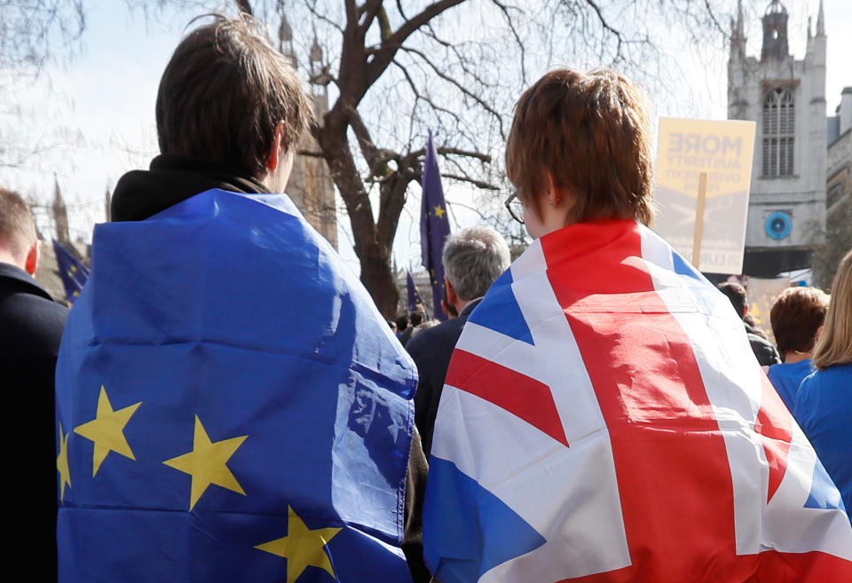 People wear a European and a Union flag during an Anti Brexit campaigners march in Parliament in London. (AP Photo/Kirsty Wigglesworth)