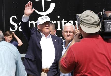 Republican presidential nominee Donald Trump and Republican U.S. vice presidential candidate Mike Pence speak with flood victims outside Greenwell Springs Baptist Church in Central, Louisiana, U.S. August 19, 2016. REUTERS/Jonathan Bachman