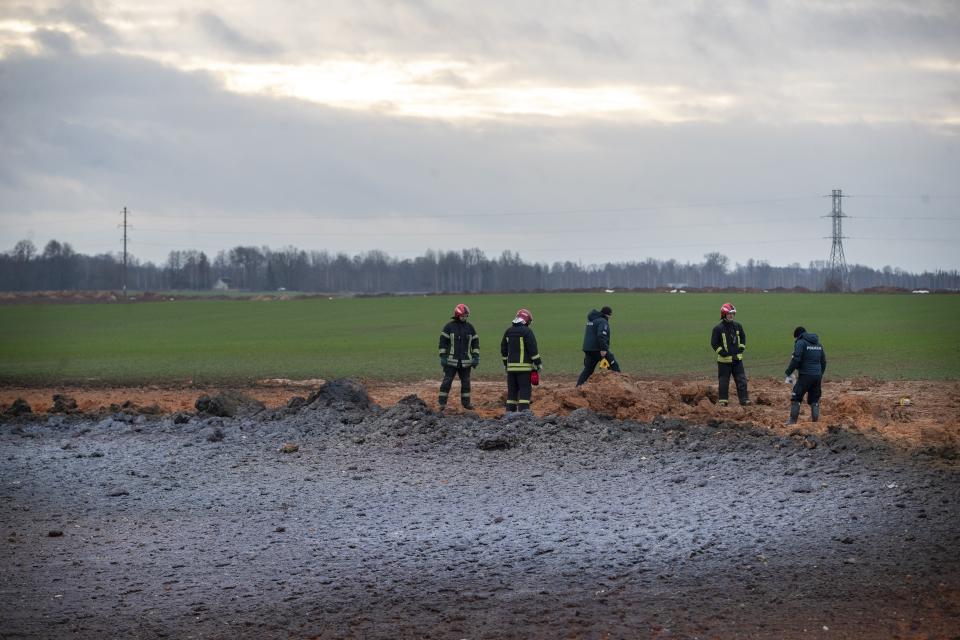 Employees work at the site of the damaged pipeline near Valakeliai village, outside Pasvalys, 175 km (109 miles) north of Vilnius in northern Lithuania on Saturday Jan. 14, 2023. A powerful gas pipeline explosion that prompted the evacuation of a village in northern Lithuania was most likely caused by a technical malfunction, the head of the country's natural gas transmission system said Saturday. The blast Friday evening sent flames 50 meters (about 150 feet) into the sky. (AP Photo/Mindaugas Kulbis)