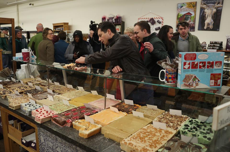 LITTLETON, NEW HAMPSHIRE - NOVEMBER 10: Democratic presidential candidate South Bend, Indiana Mayor Pete Buttigieg (C) and his husband, Chasten Glezman Buttigieg (R) visit Chutters Candy Store during a campaign stop on November 10, 2019 in Littleton, New Hampshire. Buttigieg is on day three of a four day bus tour as he campaigns across the state. (Photo by Joe Raedle/Getty Images)
