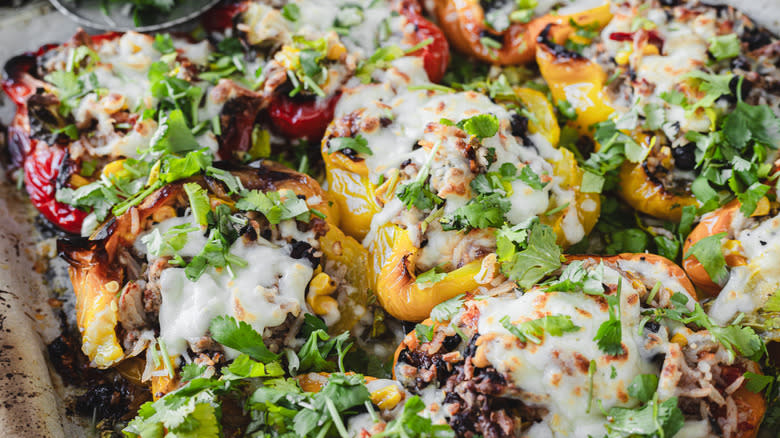 Stuffed baked peppers on baking sheet