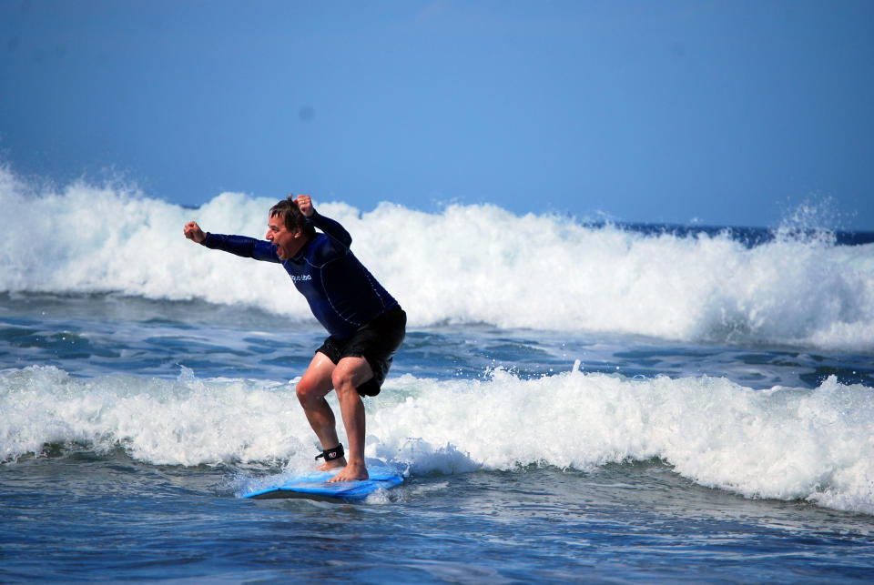 This February 2014 photo released by Kristina MacKulin shows first time surfer Andrew Dombek of N. Ferrisburg, Vt., successfully navigating the waves at Playa Guiones in Nosara, Costa Rica. Nosara is a scenic coastal region with a variety of outdoor recreation activities for visitors. (AP Photo/Kristina MacKulin)