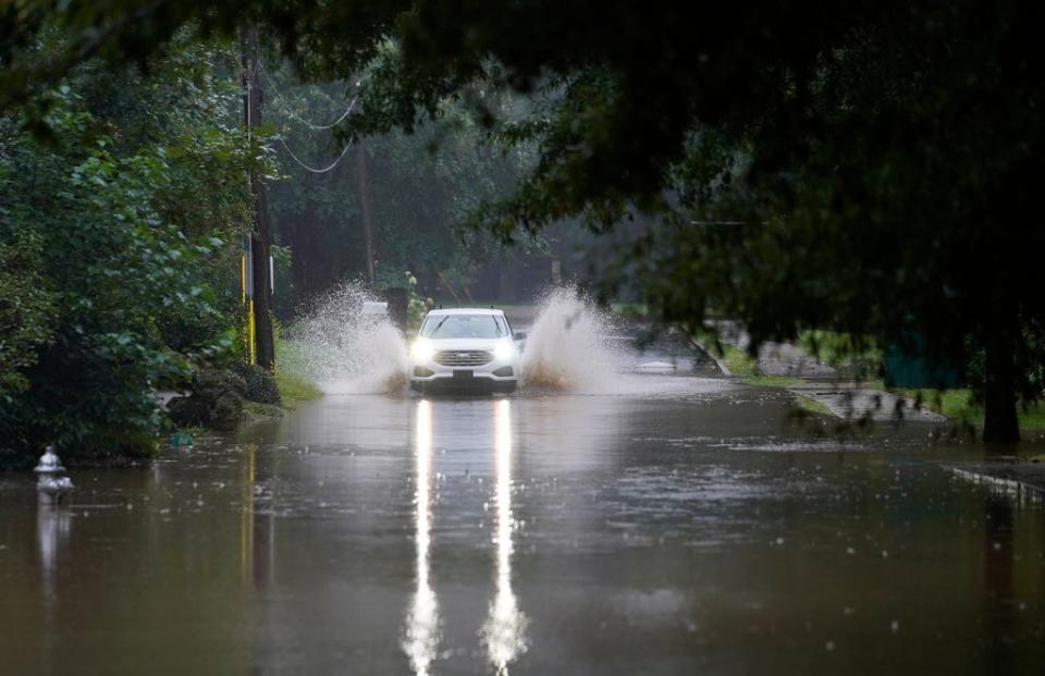 A car attempts to drive through floodwaters near Peachtree Creek near Atlanta as Tropical Storm Fred makes its way through north and central Georgia on Aug. 17.