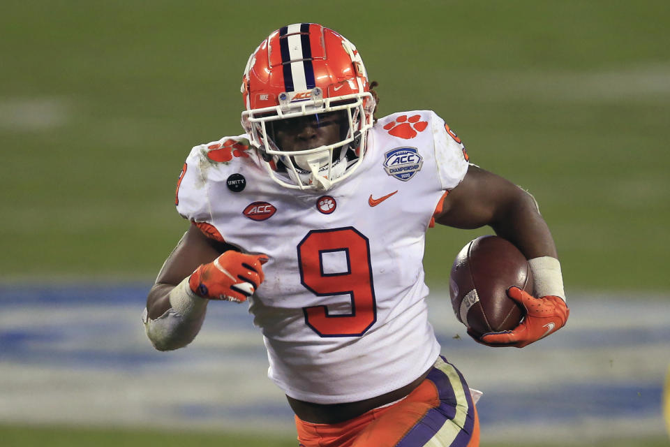 FILE - In this Saturday, Dec. 19, 2020 file photo, Clemson running back Travis Etienne (9) runs for a touchdown during the first half of the Atlantic Coast Conference championship NCAA college football game against Notre Dame in Charlotte, N.C. Brandon Beane didn’t entirely rule out the possibility of adding a running back in the first two rounds, with Clemson’s Travis Etienne and Alabama’s Najee Harris rated as the top prospects.(AP Photo/Brian Blanco, File)