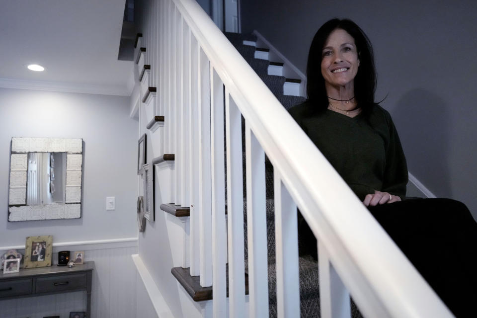 Jill Feldman, 54, poses for a photo at her home in Deerfield, Ill., Friday, Jan. 19, 2024. Lung cancer patient and advocate Jill Feldman takes pills at home that shrink tumors by blocking a signal that tells cancer cells to grow. (AP Photo/Nam Y. Huh)