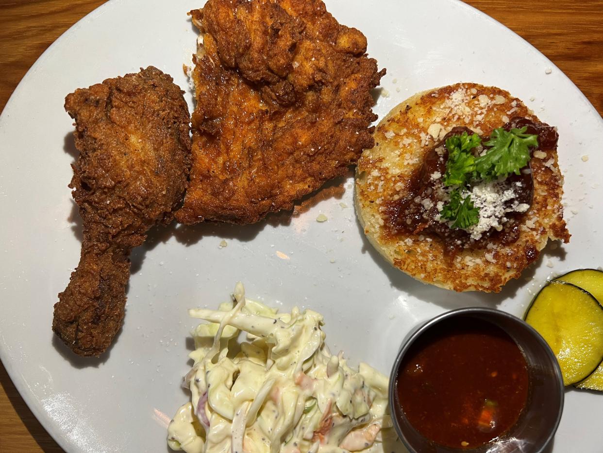 Korean fried chicken with coleslaw and a fresh biscuit with tomato jam