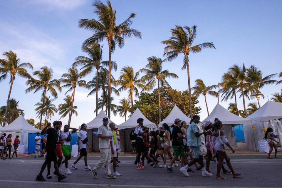 People walk down Ocean Drive during spring break in Miami Beach, Florida, on Saturday, March 18, 2023.