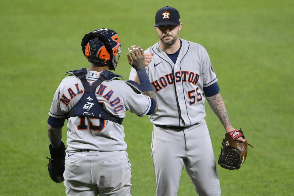 Houston Astros relief pitcher Ryan Pressly (55) and catcher Martin Maldonado (15) celebrate after a baseball game against the Baltimore Orioles, Tuesday, June 22, 2021, in Baltimore. (AP Photo/Nick Wass)