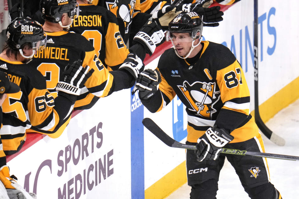 Pittsburgh Penguins' Sidney Crosby (87) returns to the bench after scoring during the first period of an NHL hockey game against the Philadelphia Flyers in Pittsburgh, Sunday, Feb. 25, 2024. (AP Photo/Gene J. Puskar)