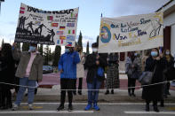 People with banners waiting for welcoming the Pope Francis outside of the Saint Dionysius School of the Ursuline Sisters in Athens, Greece, Monday, Dec. 6, 2021. Francis' five-day trip to Cyprus and Greece has been dominated by the migrant issue and Francis' call for European countries to stop building walls, stoking fears and shutting out "those in greater need who knock at our door." (AP Photo/Thanassis Stavrakis, Pool)