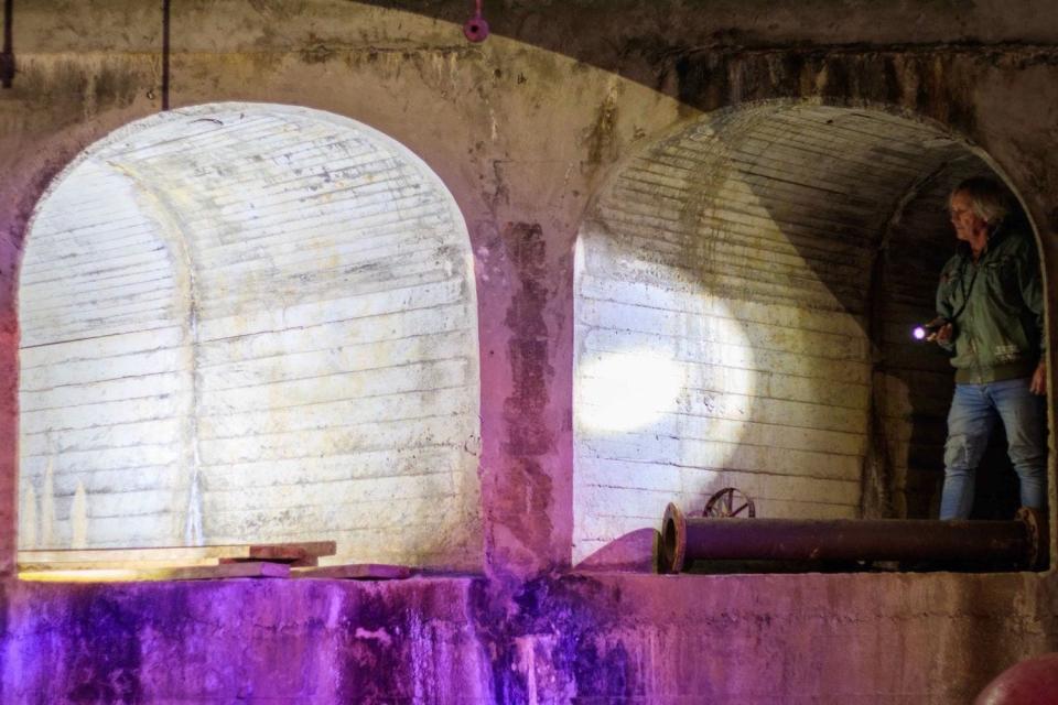 A person walks through the Fort Stony Batter tunnels.