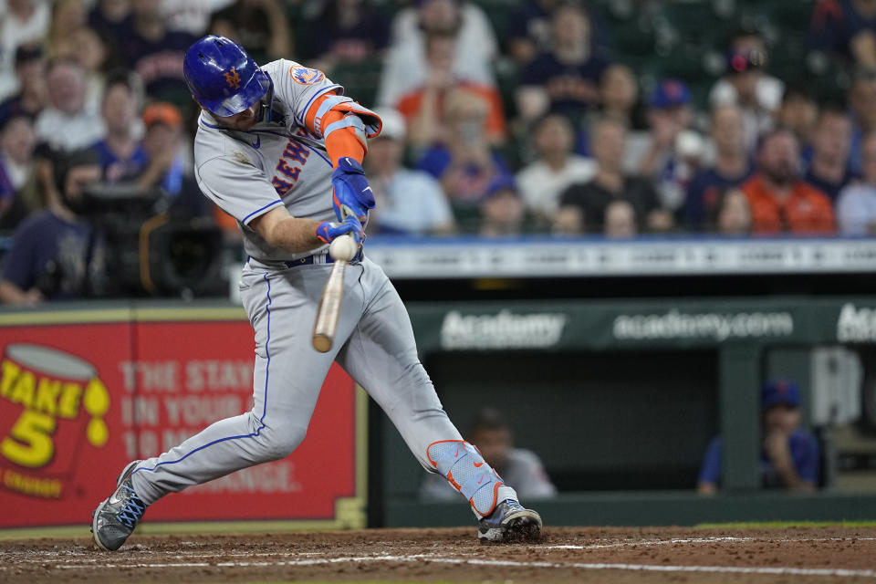 New York Mets' Pete Alonso hits a sacrifice fly against the Houston Astros during the sixth inning of a baseball game Wednesday, June 22, 2022, in Houston. (AP Photo/David J. Phillip)