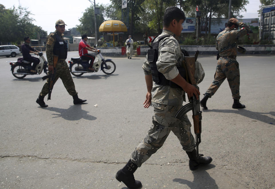 Police inspect the site of a rocket attack in the city of Kabul during Independence Day celebrations at the Defense Ministry in Kabul, Afghanistan, Tuesday, Aug. 18, 2020, Several mortar shells slammed into various part of Kabul on Tuesday morning as Afghans marked their country's Independence Day amid new uncertainties over the start of talks between the Taliban and the Kabul government. (AP Photo/Rahmat Gul)