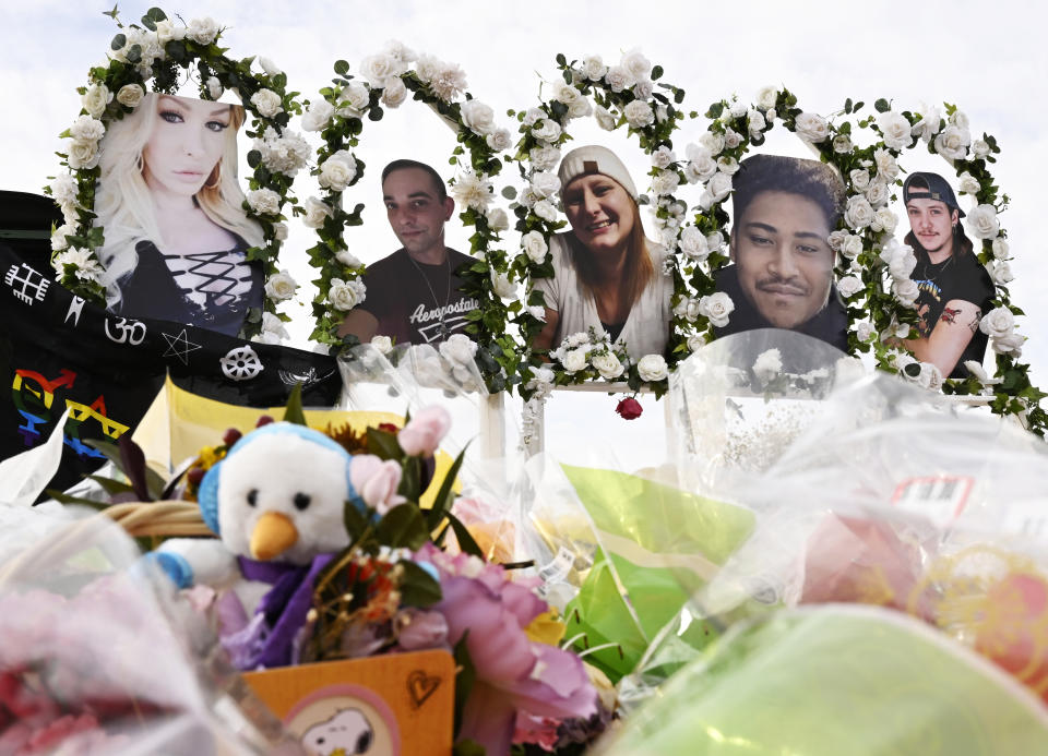 Photographs of victims of the Club Q mass shooting are seen at a memorial.