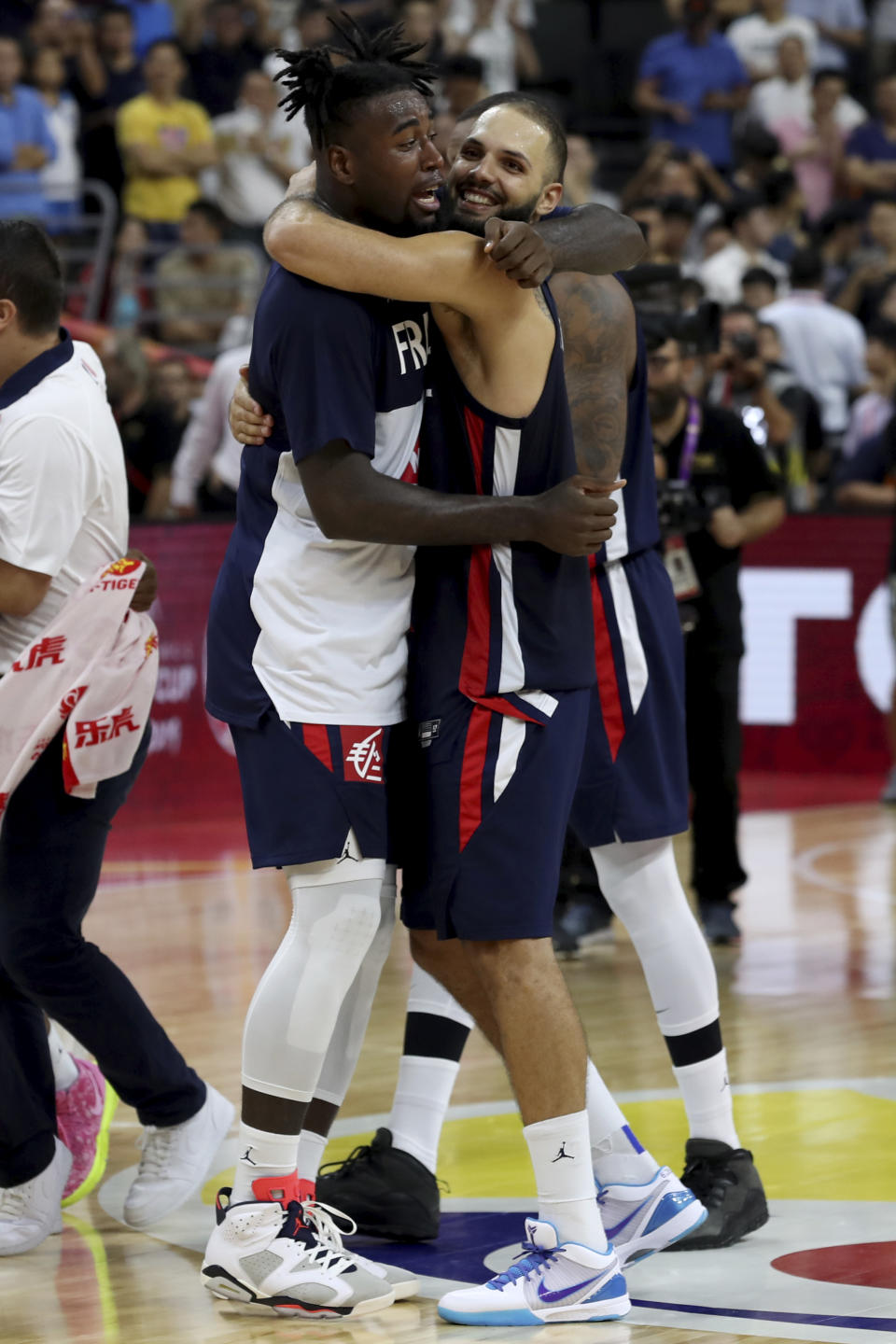 France's Mathias Lessort at left hugs France's Evan Fournier as they celebrate defeating United States during a quarterfinal match for the FIBA Basketball World Cup in Dongguan in southern China's Guangdong province on Wednesday, Sept. 11, 2019. France defeated United States 89-79. (AP Photo/Ng Han Guan)