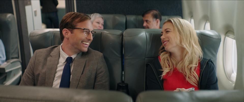 dennis kelly (played by ryan hansen) and andrea singer (played by iliza shlesinger) in good on paper airplane scene