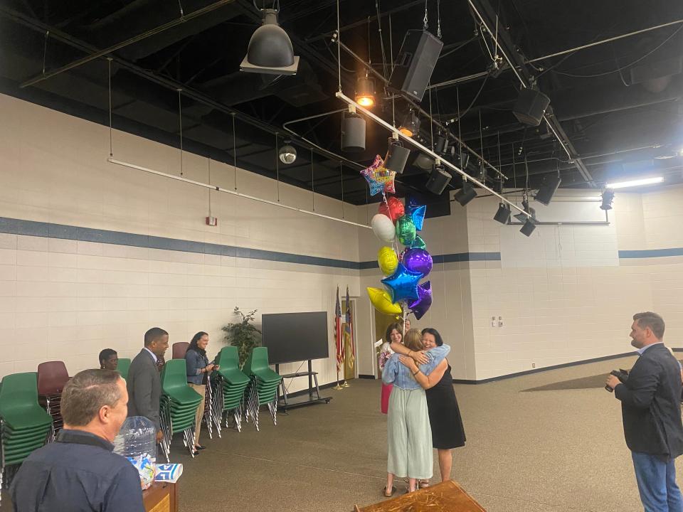 Principal Carrie Buchanan and Maggie Allen hug during celebration ceremony at Hall Fletcher.