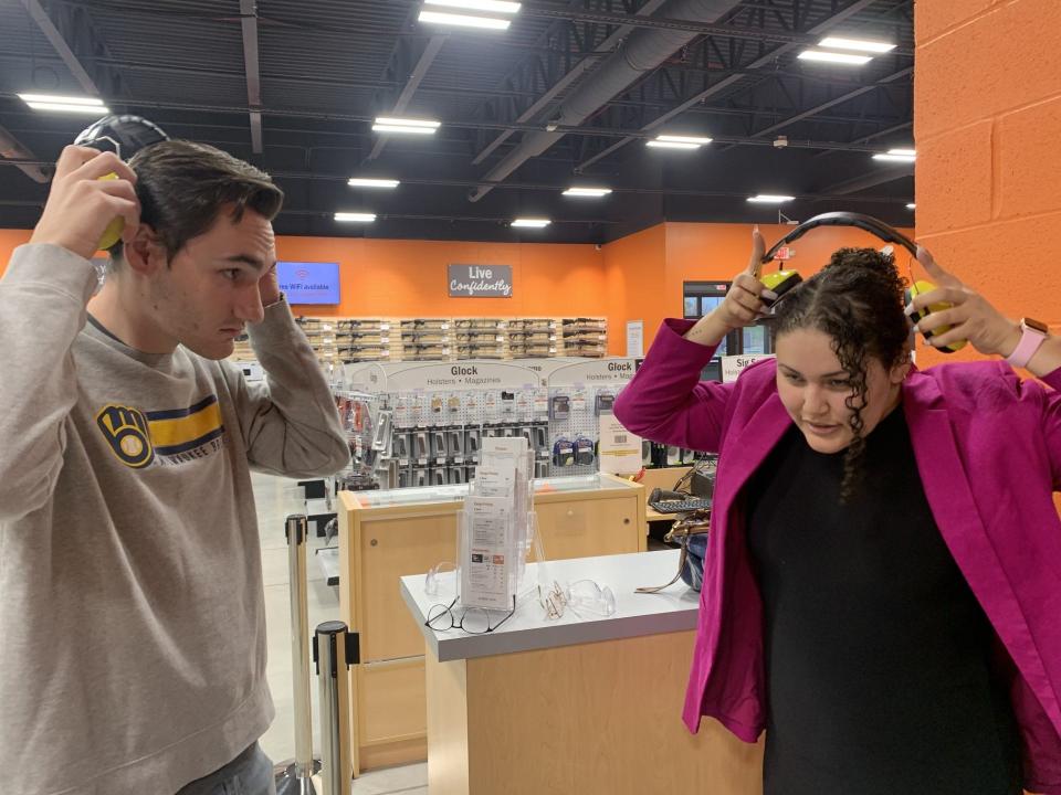 Marquette University students Ben Schultz, left, and Alex Rivera Grant put on ear protection as part of a firearms safety class at Range USA in November 2022. They worked on a project about gun deaths through the O'Brien Fellowship for Public Service Journalism.