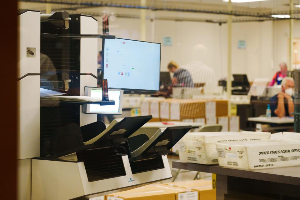 A HiPro tabulation machine scans early voter mail-in ballots at the Maricopa County Tabulation and Election Center on Aug. 1, 2022, in Phoenix.