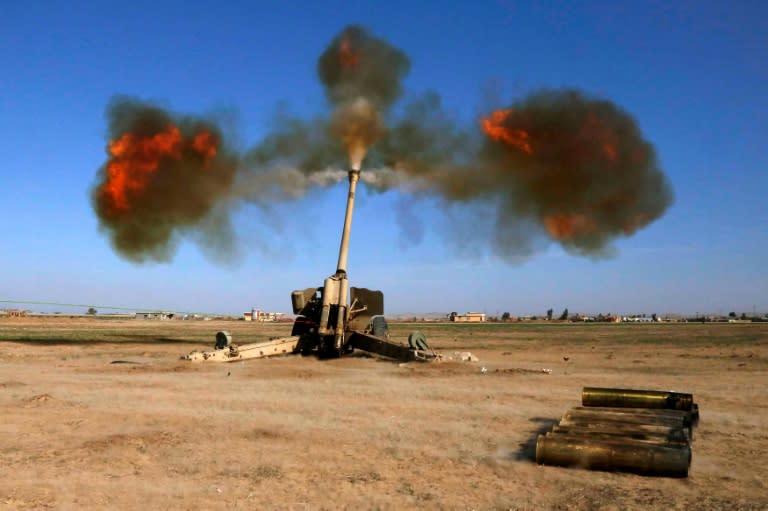 Iraqi fighters from the Abbas Brigade, under the umbrella of the Shiite popular mobilisation units, fire towards enemy positions in village of Badush, some 15 kilometres northwest of Mosul, on March 9, 2017