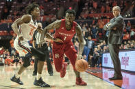 Rutgers' Akwasi Yeboah (1) drives the ball against Illinois' Ayo Dosunmu (11) as Rutgers head coach Steve Pikiell watches on the sideline in the second half of an NCAA college basketball game, Sunday, Jan. 11, 2020, in Champaign, Ill. (AP Photo/Holly Hart)