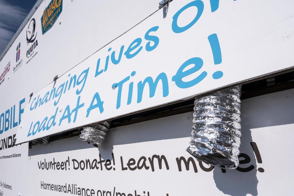 A sign is seen on the Homeward Alliance's mobile laundry truck during a drop-off at the Fullana Learning Center on Tuesday, July 17, 2024, in Fort Collins, Colo. The laundry truck was damaged in a crash nearly five months ago was recently repaired.