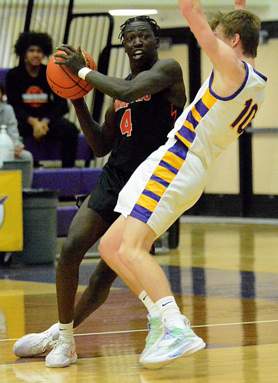 Watertown's Kohen Kranz (10) takes a charge from Sioux Falls Washington's Mandall Mohamed during a high school boys basketball game on Friday, Feb. 3, 2023 in the Watertown Civic Arena.