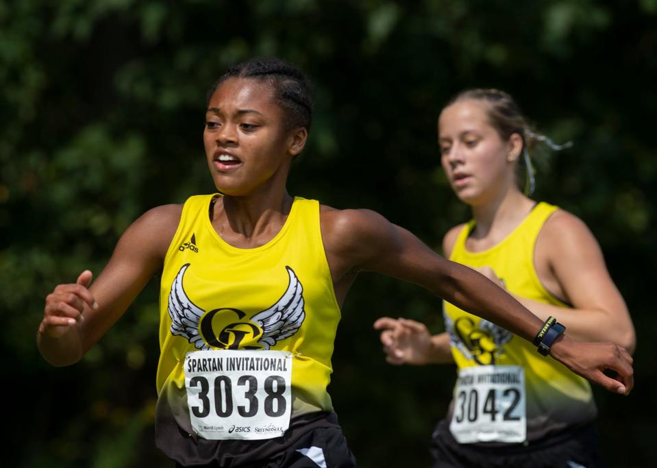 JaNasia Moore and Megan Schaefer of Garfield compete at the Spartan Invitational, held last Saturday at Boardman High School.