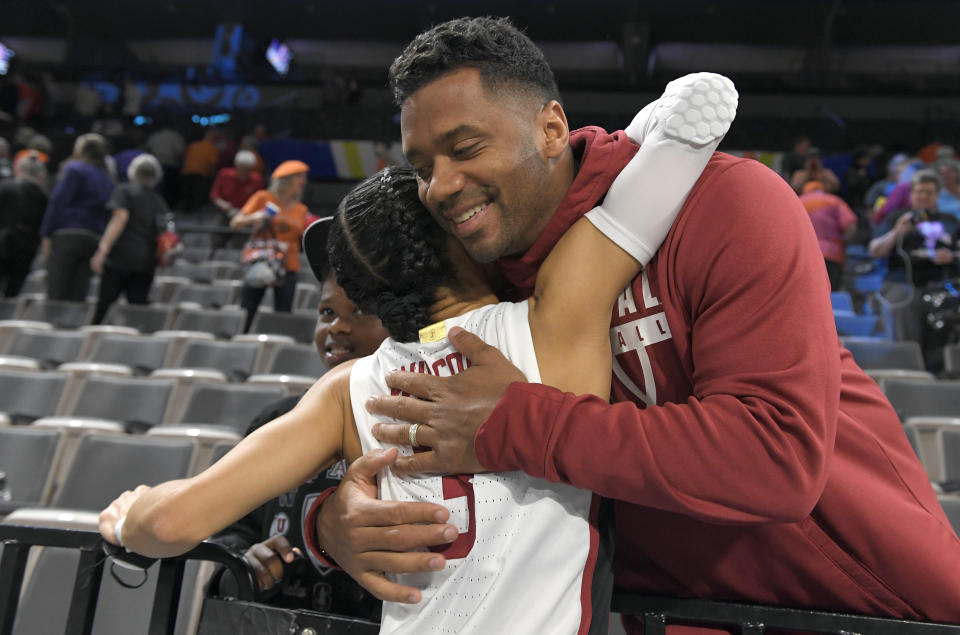 Stanford guard Anna Wilson is hugged by her brother, NFL player Russell Wilson, after the Cardinal defeated Oregon State in an NCAA college basketball game in the quarterfinals of the Pac-12 women's tournament Thursday, March 3, 2022, in Las Vegas. (AP Photo/David Becker)