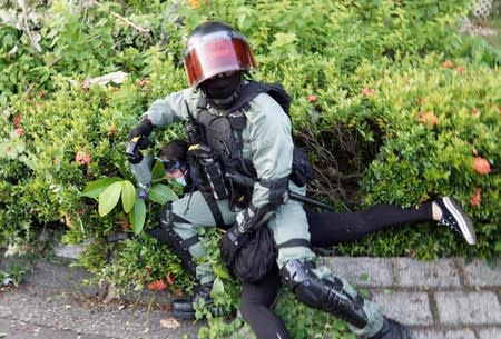 A police officer detains an anti-government protester in Sha Tin, Hong Kong