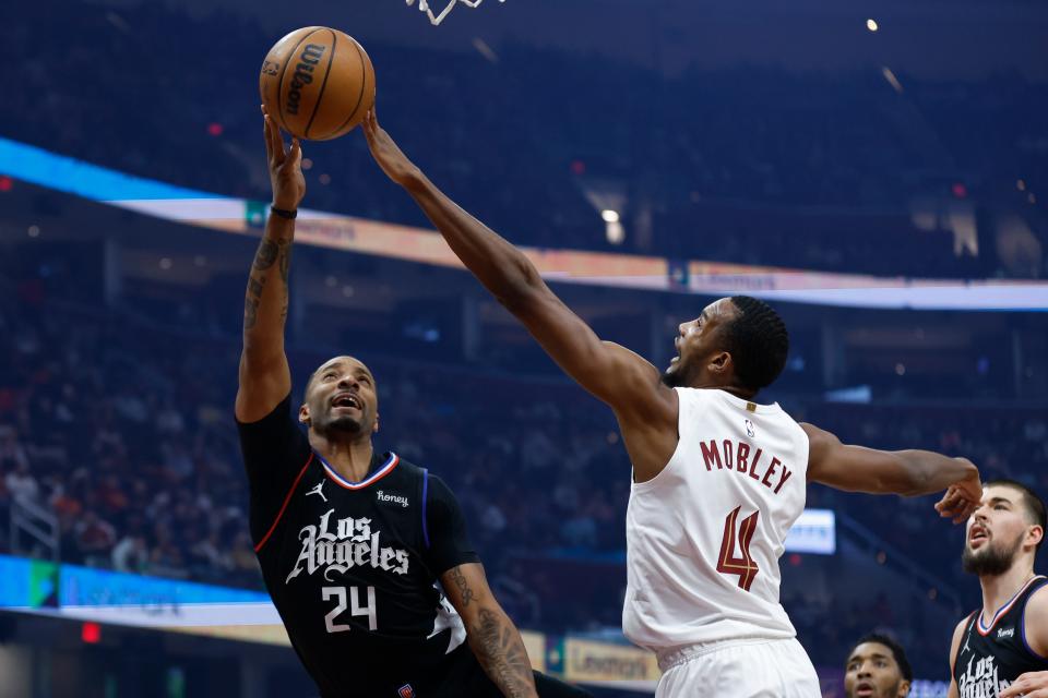 Cleveland Cavaliers forward Evan Mobley (4) blocks a shot by Los Angeles Clippers forward Norman Powell (24) during the first half of an NBA basketball game, Sunday, Jan. 29, 2023, in Cleveland. (AP Photo/Ron Schwane)