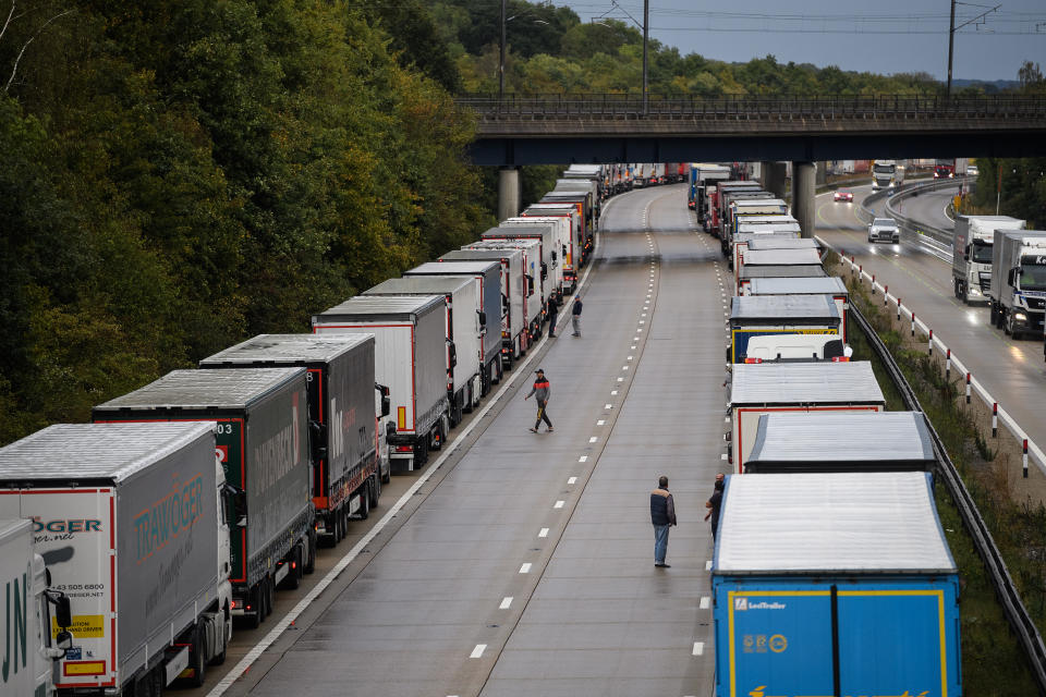 ASHFORD, ENGLAND - SEPTEMBER 24: Lines of heavy goods vehicles and cargo lorries are seen queued along the M20 motorway as part of the Operation Stack traffic control plan, on September 24, 2020 near Ashford, England. Due to industrial action in Calais, vehicles were backed up along the motorway to prevent overcrowding and gridlock in the port of Dover. (Photo by Leon Neal/Getty Images)