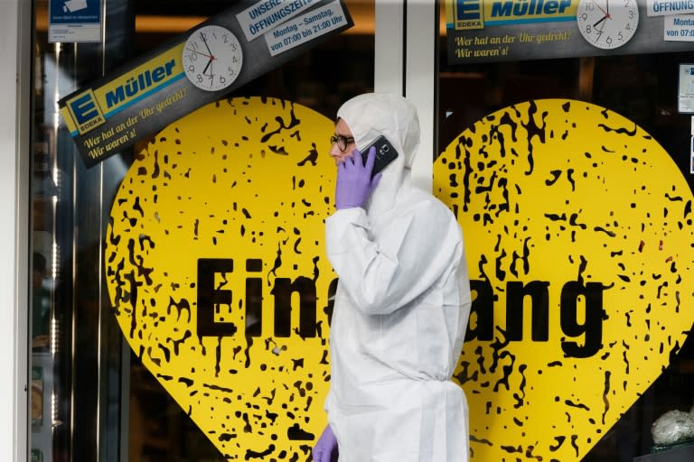 A police investigator works at the area around a supermarket in the northern German city of Hamburg