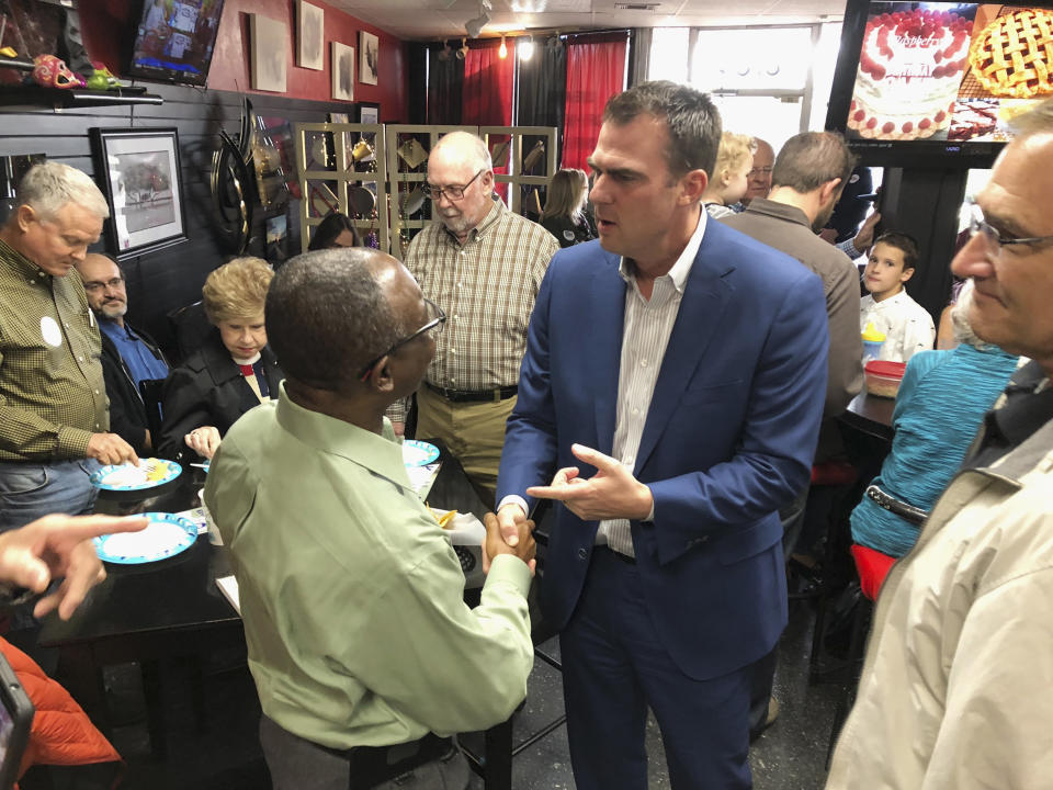 In this Oct. 12, 2018, photo, Kevin Stitt, the Republican nominee for Oklahoma governor, greets guests at Java 39 coffeehouse in Bethany, Okla. Stitt is locked in a tight race with Democrat Drew Edmondson to replace term-limited GOP Gov. Mary Fallin. (AP Photo/Sean Murphy)