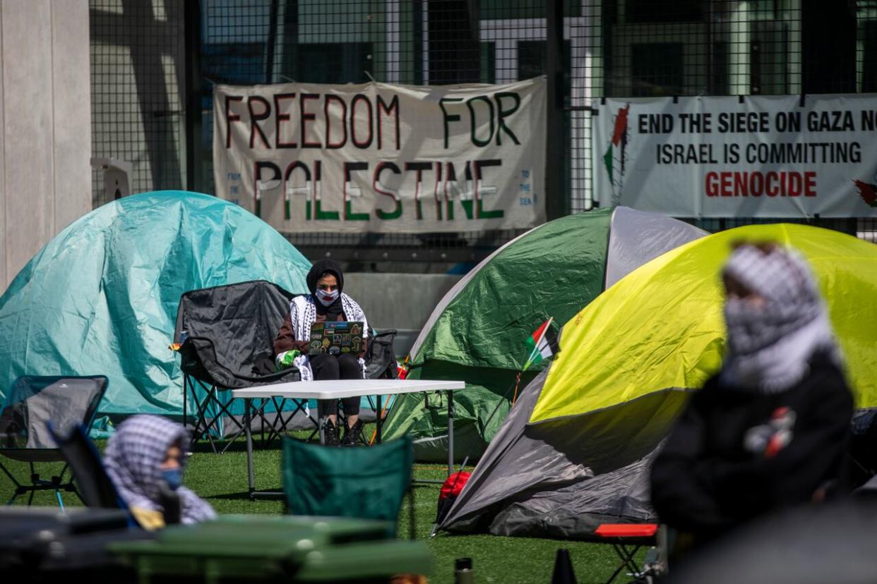 Palestinian supporters are pictured while setting up an encampment at the University of British Columbia on Monday.  (Ben Nelms/CBC - image credit)