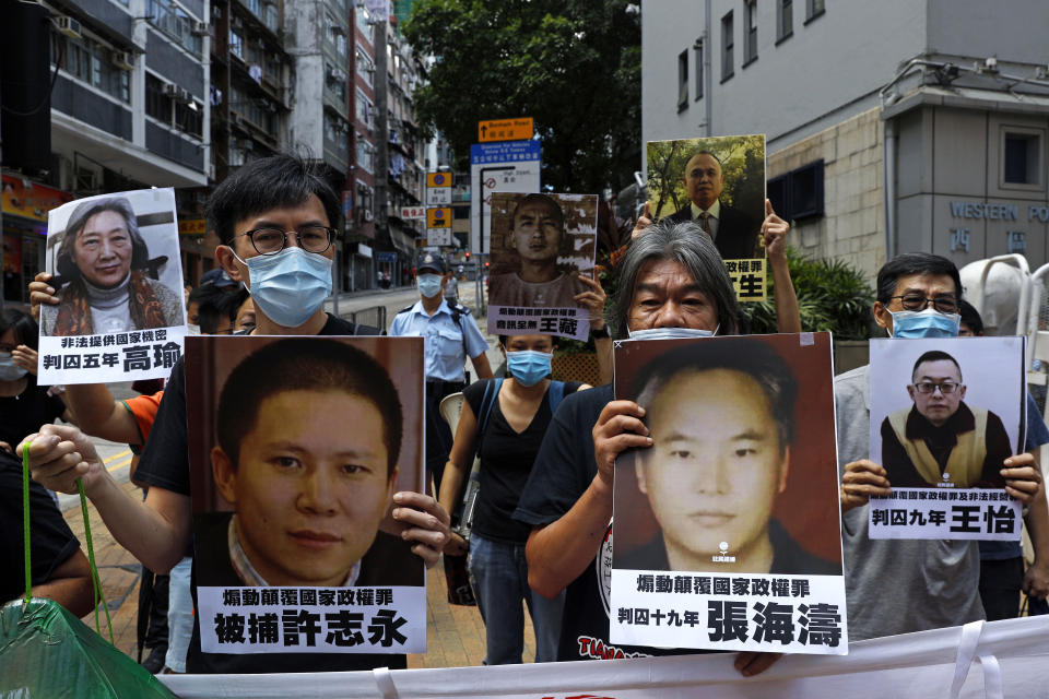 Pro-democracy demonstrators hold up portraits of jailed Chinese civil rights activists, lawyers and legal activists as they march to the Chinese liaison office in Hong Kong, Thursday, June 25, 2020. They demand to abolish the national security law and defend human rights and freedom in Hong Kong. (AP Photo/Kin Cheung)